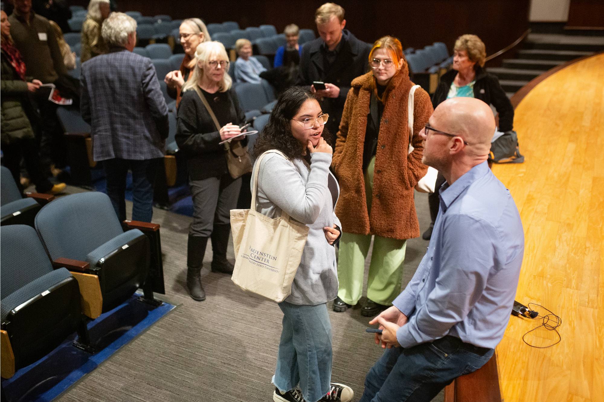 two people sitting on stage